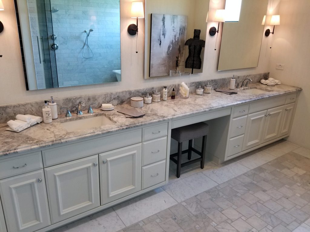white bathroom cabinets with dark countertops