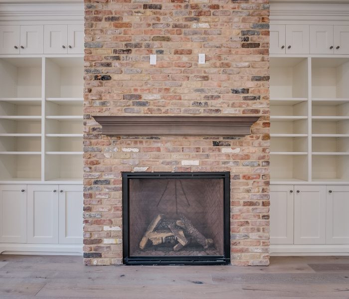 transitional style bookcase fireplace in white and antique brick