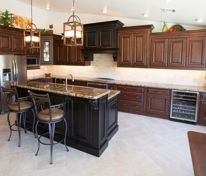 transitional style kitchen in two tone black and dark wood stain with natural stone quartz countertops