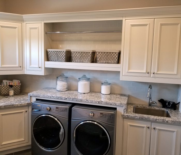 transitional style laundry room in white with quartz countertop