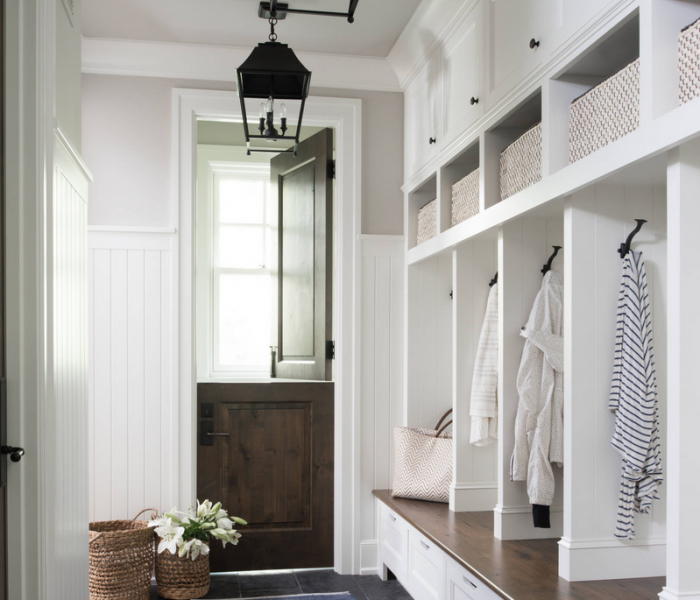 shaker style mudroom cabinetry in white with dark stained wood bench