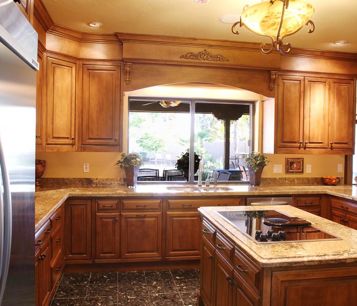 traditional style kitchen in dark wood stain with natural stone quartz countertops